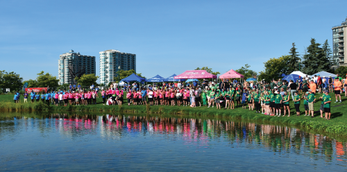 Paddlers gather around the Heritage Park pond with carnations
